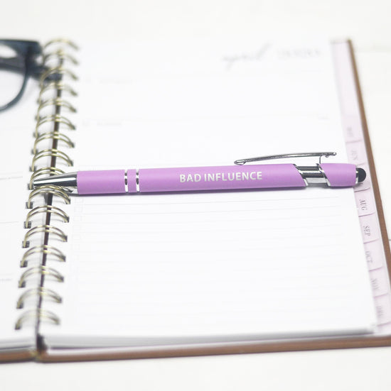 Black ink pen in the color pink with the word Bad Influence on it.