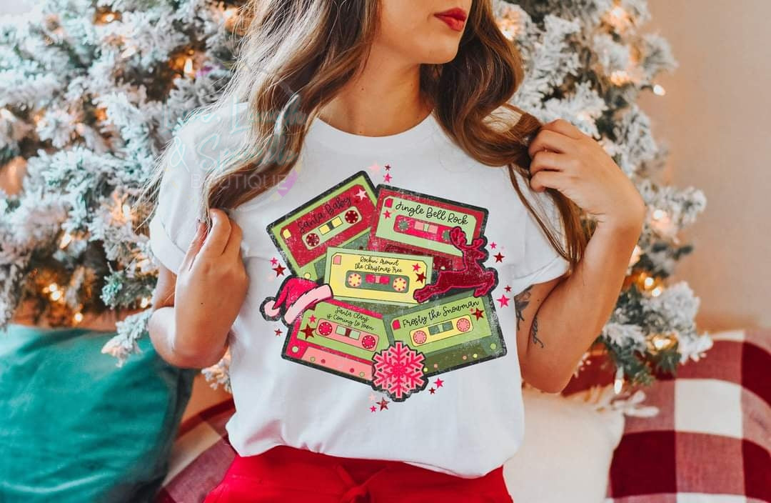 T-shirt with cassette tapes with Christmas songs on it.